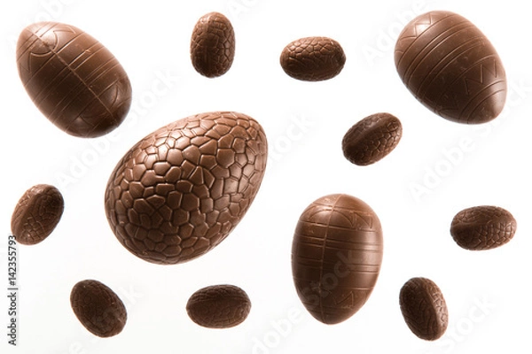 Obraz High angle view of a variety of unwrapped Easter chocolate eggs on a white background
