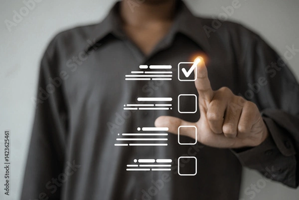 Obraz A person touches a virtual checklist interface, highlighting a glowing checkmark to represent task completion or selection.