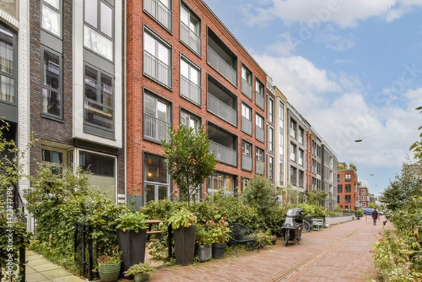 Obraz Contemporary residential buildings showcase sleek designs and harmonious layouts, surrounded by lush greenery and walkable paths, emphasizing urban living.