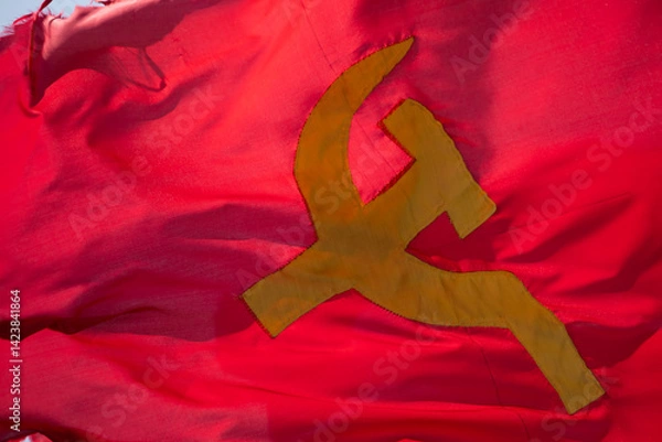 Obraz Red communist flag with hammer and sickle, handmade, irregularly, waving in the wind in Laos
