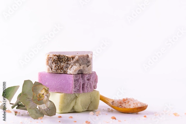 Obraz Bright composition with set of natural eco spa and wellness products such as handmade soap, essential oils, Himalaya salt, massage brushes and fresh green twigs on white background, selective focus.