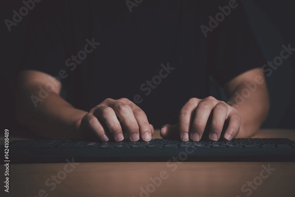 Obraz Close-up of hands typing on a keyboard in a dark room, representing cybersecurity, hacking, or late-night programming.