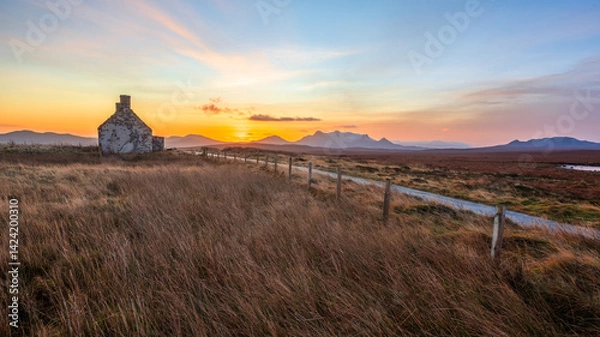 Fototapeta Sunrise behind the Moine House. A ruin of a stone cottage in the remote moorland in Sutherland in the far north of the Scottish Highlands.