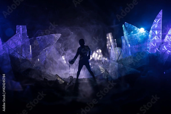 Obraz A silhouette of a person against the background of shattered glass. An abstract world made of glass shards. Surreal concept. Table top decoration.