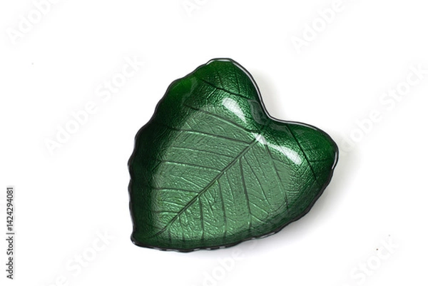 Fototapeta Green glass bowl shaped like a leaf with detailed veins, isolated on white background. Elegant tableware with a nature-inspired design.