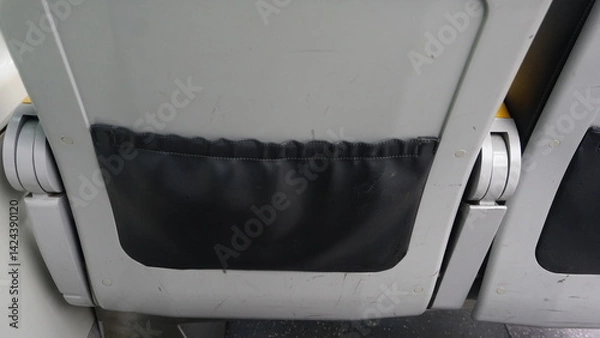 Fototapeta An appearance from behind a seat in an airplane
