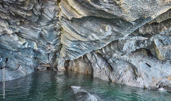 Fototapeta Interior of the flooded Marble Caves, unique rock formations in the General Carrera Lake, Chile. The walls of the caves have swirling mineral patterns. Turquoise water fills the caves with blue light.