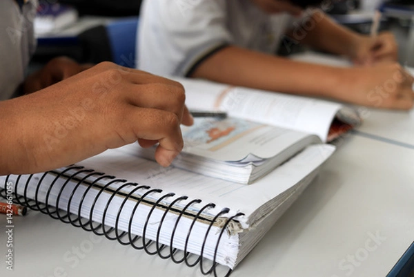Fototapeta Student at school in the classroom doing activity.
