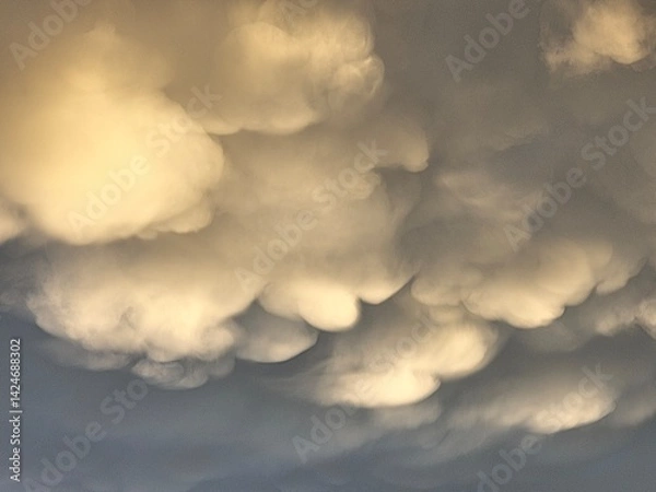 Obraz Storm clouds on sunset. Light in the dark and dramatic storm clouds. Background of storm clouds before a thunderstorm. Mammatus clouds