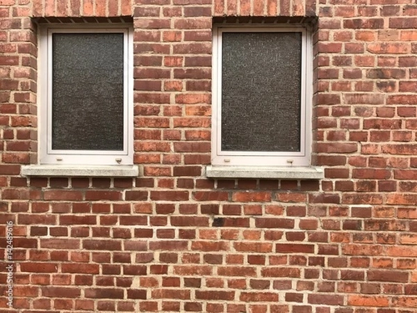 Fototapeta Windows and beautiful rough Brick wall facade