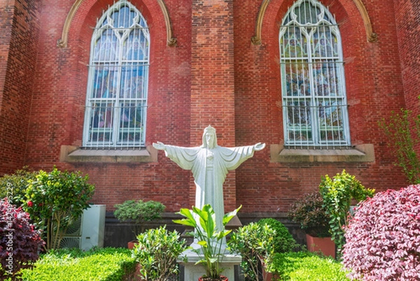 Fototapeta Jesus statue in garden at St. Ignatius Xujiahui Cathedral, Shanghai