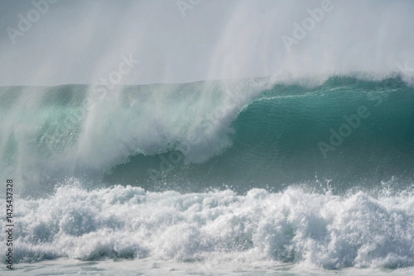 Obraz Massive waves roar and break under the golden glow of the sun