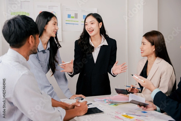 Obraz Brainstorming of young modern group. Team meeting to achieve goal. Business people discussing finance business and analysis. Teamwork concept in modern office. Calculating personal tax for client.