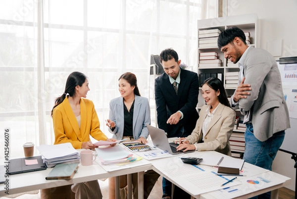 Obraz Brainstorming of young modern group. Team meeting to achieve goal. Business people discussing finance business and analysis. Teamwork concept in modern office. Calculating personal tax for client.