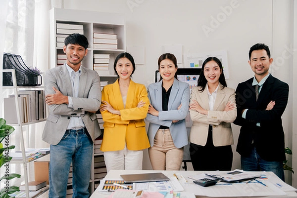 Obraz Brainstorming of young modern group. Team meeting to achieve goal. Business people discussing finance business and analysis. Teamwork concept in modern office. Calculating personal tax for client.