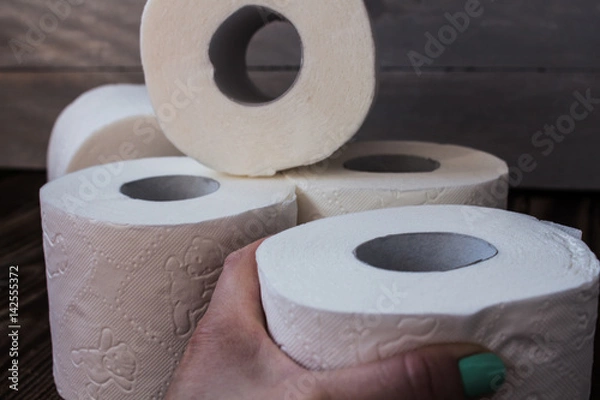 Fototapeta lot of toilet paper and a hand