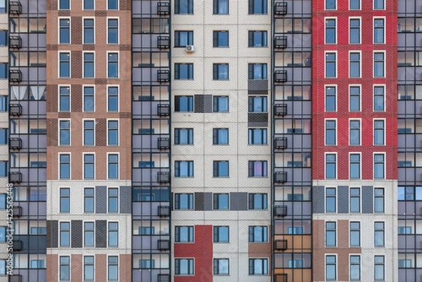 Obraz A fragment of the wall of a modern multi-storey building with identical windows and balconies