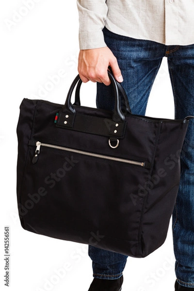 Fototapeta A man in a classic suit holds a black briefcase
