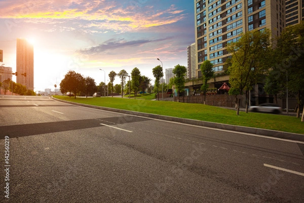 Obraz Empty road surface floor with City streetscape buildings
