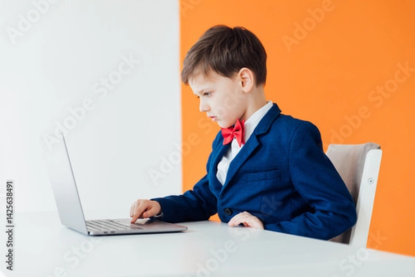 Obraz Boy in school uniform working on laptop