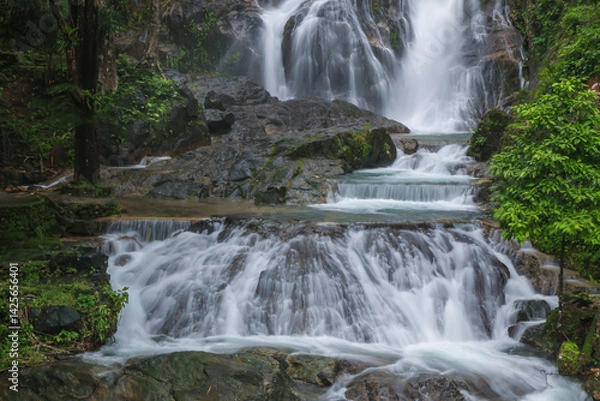 Fototapeta Punyaban Waterfall is a waterfall with water flowing all year round, located on Phetkasem Road, 2 kilometers from the National Park Office. It has 3 levels and is located in Mueang District, Ranong