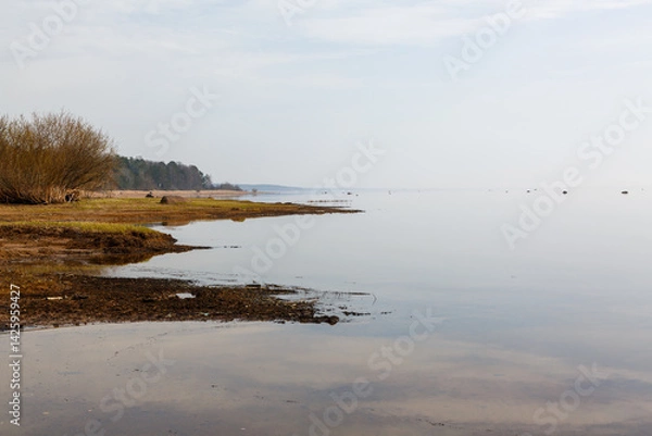 Fototapeta The seashore after low tide on a cloudy day.