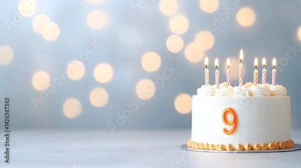 Fototapeta Festive ninth birthday cake with lit candles against a bokeh background