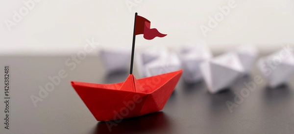Obraz Red origami boat with a small flag positioned on the right against a clean white background.