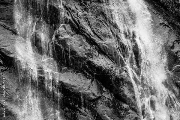Fototapeta Water rushes over sharp rock face in Endicott Arm of Alaska