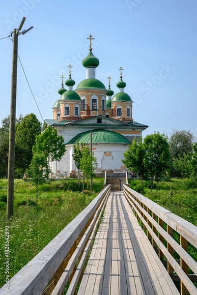 Obraz Wooden bridge leading to the Cathedral of Our Lady of Smolensk on an island among the woods in Olonets, Karelia, in summer