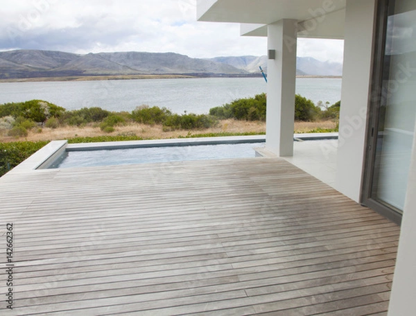 Obraz External view of a contemporary house with pool at dusk