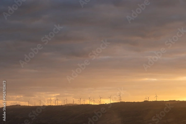 Obraz Find the support type and plan that works best for your needs, wind turbines on a green field with clouds and blue sky and a mountain range in the distance, north of waterton- alberta