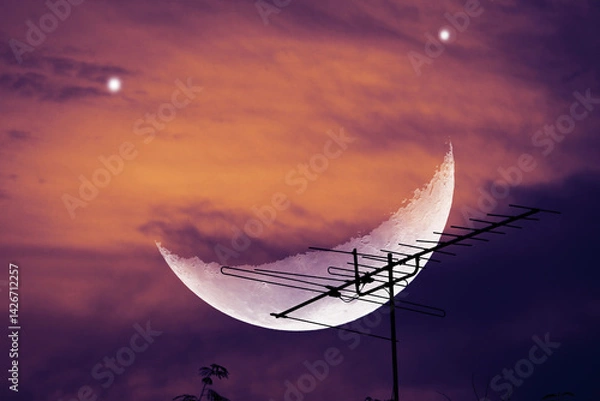 Obraz Dramatic Sky with Crescent Moon and Antenna Silhouette at Dusk