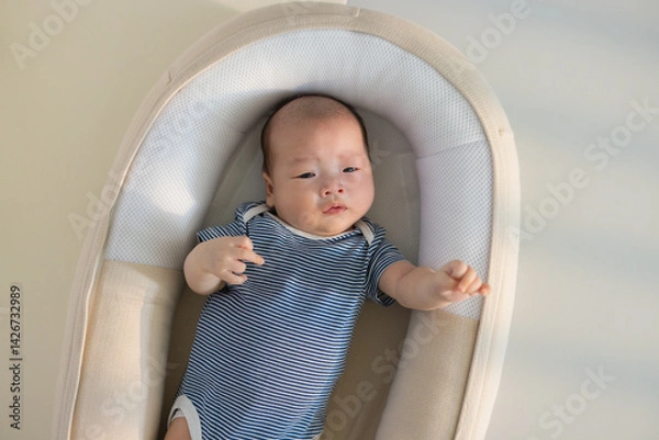 Obraz Cute infant napping alone in baby crib