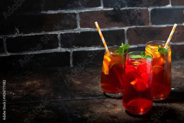 Obraz glasses of refreshing iced tea, fruity and black, closeup