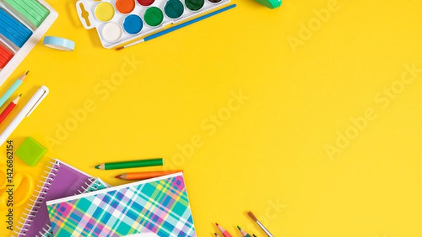 Fototapeta Back to school concept. Frame made of colorful school supplies, paints, plasticine, notepad, scissors, pens, sharpener on a yellow background. Flat lay, top view, copy space.