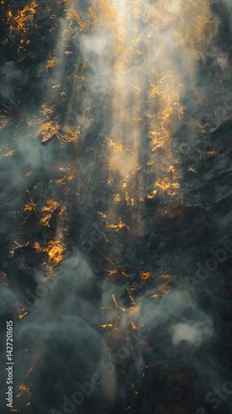 Fototapeta Sunlight piercing through swirling smoke above burning dry grass in a moody abstract landscape