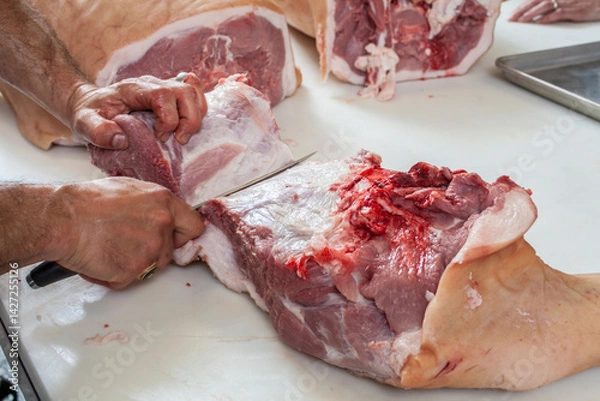 Obraz Cutting raw meat on a cutting board