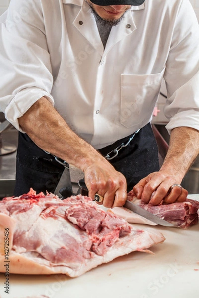 Obraz butcher breaking down meat