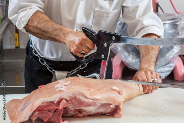 Obraz Butcher cutting meat