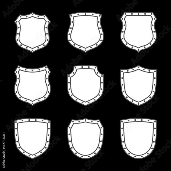 Fototapeta Shield shape icons set. White label signs isolated on black background. Symbol of protection, arms, security, safety. Flat retro style design. Element vintage heraldic emblem Vector illustration