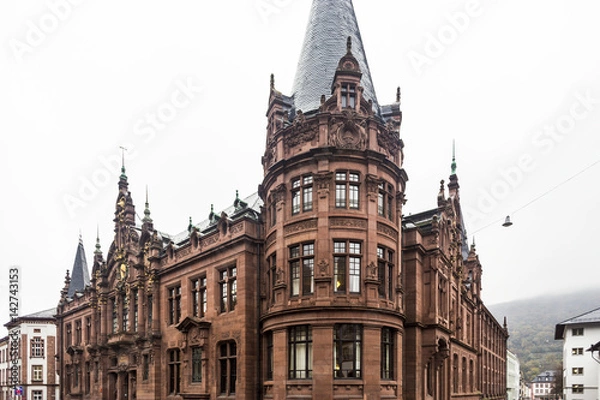 Fototapeta Heidelberg University Library viewed from crossing of Ploeck and Grabengasse on autumn cloudy day in Heidelberg, Germany