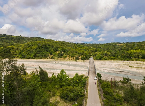 Fototapeta Aerial view of the construction of a bridge over a river crossing in Hatu Bulico Village, Ainaro Municipality, Timor Leste. The development of transportation access is still very much needed in Timor 