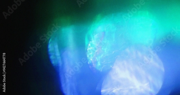 Fototapeta Blurred blue and green light bokeh. Abstract background texture. Ideal for overlay or design art.