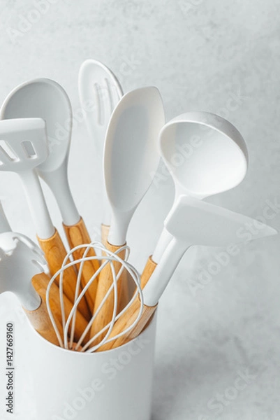 Fototapeta Kitchen utensils in a white container for cooking and baking activities