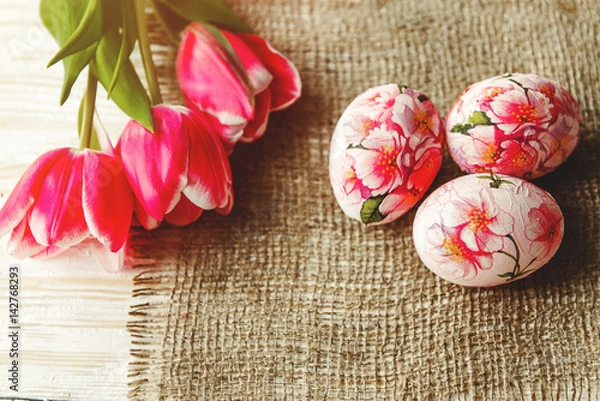 Obraz Decorated with painted Easter eggs and flowers on a light background