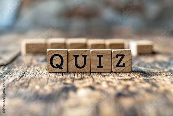 Obraz Wooden letter blocks spelling "QUIZ" placed on a rustic wooden surface with blurred background. Great for education, trivia games, learning tools, and test-related themes.