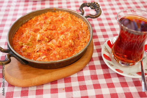 Obraz Traditional Turkish menemen served with tea on a checkered tablecloth