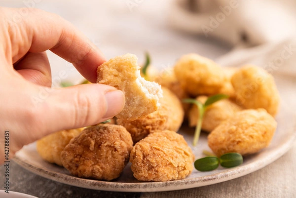 Obraz Fried crispy Chicken Nuggets with ketchup, microgreen on brown concrete with hand. Diet, healthy eating. side view, selective focus