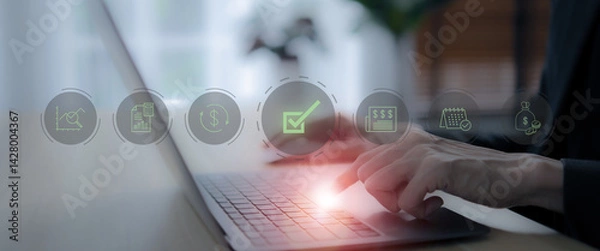 Obraz Digital financial approval concept. A person works on a laptop with floating digital icons representing financial operations, including a green checkmark indicating successful approval.